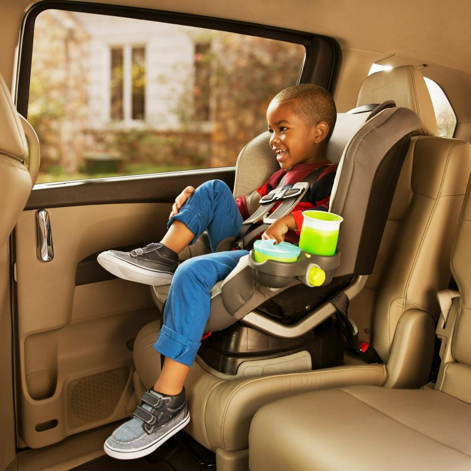 green drink and snack cup holder attached to child's car seat