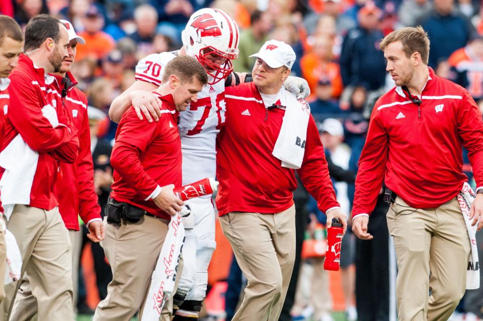 Wisconsin lineman Dan Voltz (70) is helped off the field against Illinois Saturday, Oct. 24, 2015 at Memorial Stadium in Champaign, Ill. (AP Photo/Bradley Leeb)