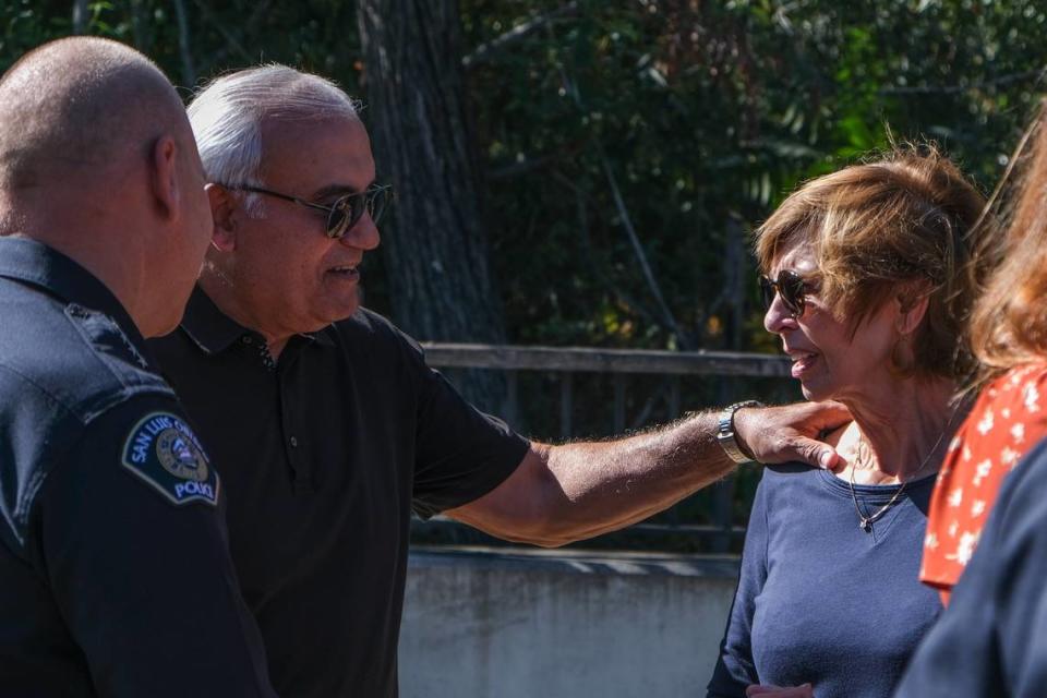 Ernie Chachere touches the shoulder of his wife, Linda Chachere, during a memorial for their son, Matthew Chachere, and their son’s girlfriend, Jennifer Besser, in San Luis Obispo on Oct. 21, 2023. Besser and Chachere were killed by a vehicle in November 2022.