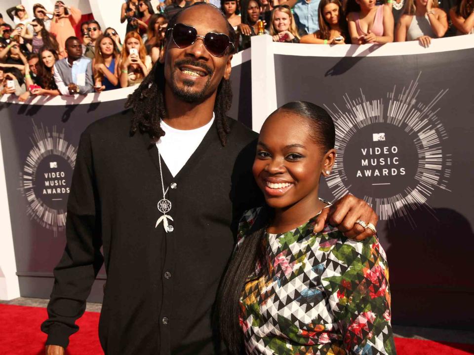 <p>Christopher Polk/Getty</p> Snoop Dogg and his daughter Cori Broadus at the 2014 MTV Video Music Awards