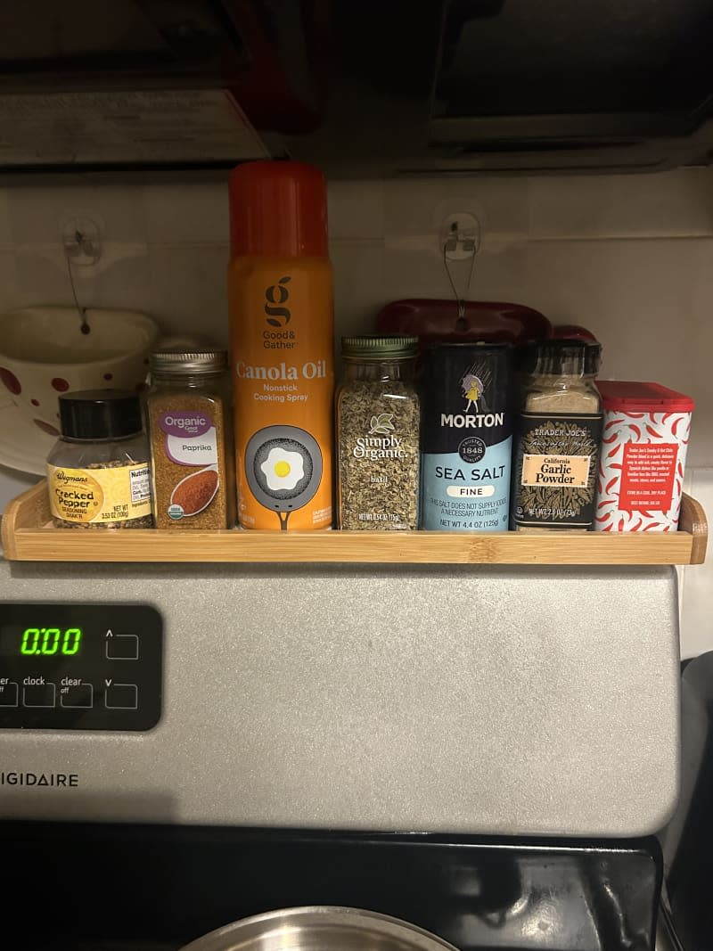 assorted spices on stovetop bamboo organizer