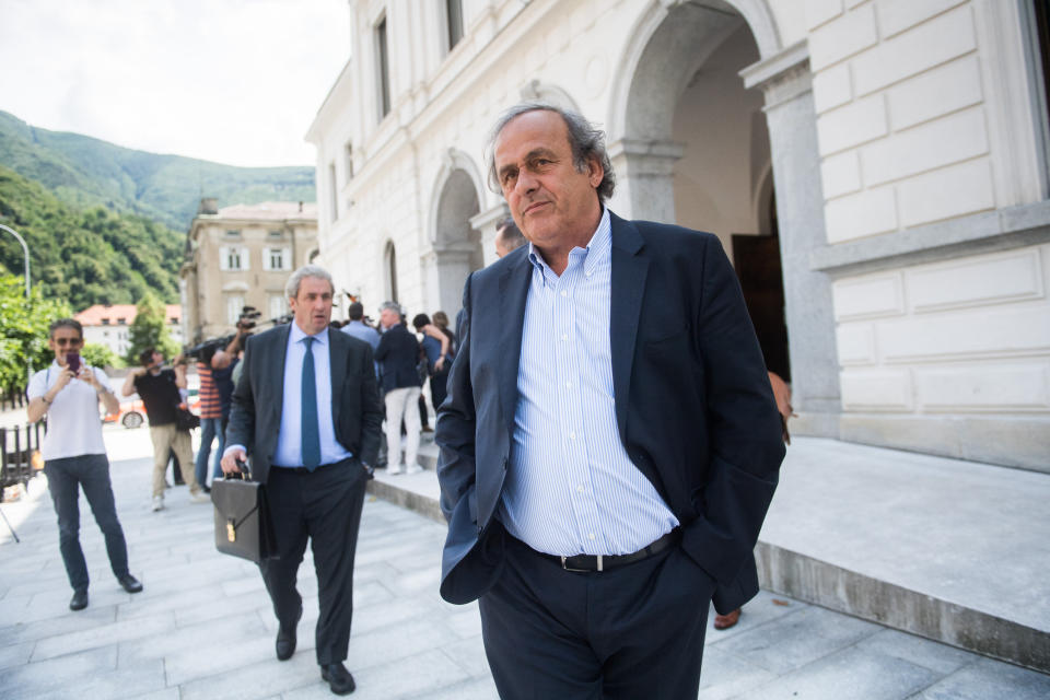 The former president of the the European Football Association (Uefa) Michel Platini, center, is leaving the Swiss Federal Criminal Court in Bellinzona, Switzerland, after the first day of his trial, Wednesday, June 8, 2022. Platini and the former president of the World Football Association (Fifa), Joseph Blatter, stand trial before the Federal Criminal Court from Wednesday, over a suspicious two-million payment. The Federal Prosecutor's Office accuses them of fraud. The defense speaks of a conspiracy. (Ti-Press/Alessandro Crinari/Keystone via AP)