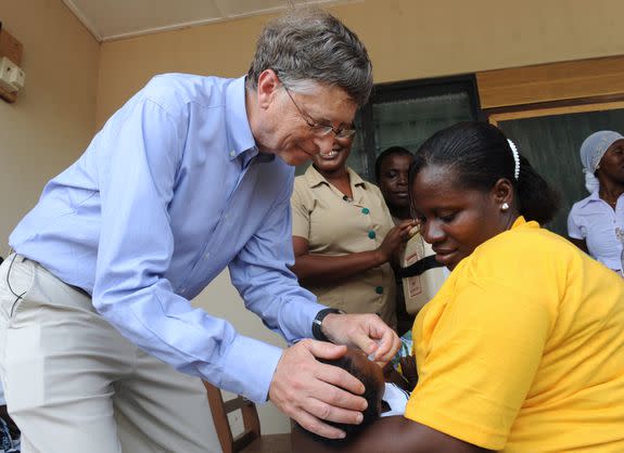 In Ghana to discuss public health solutions, Bill Gates gives a child a rotavirus vaccine against diarrhea on March 26, 2013.