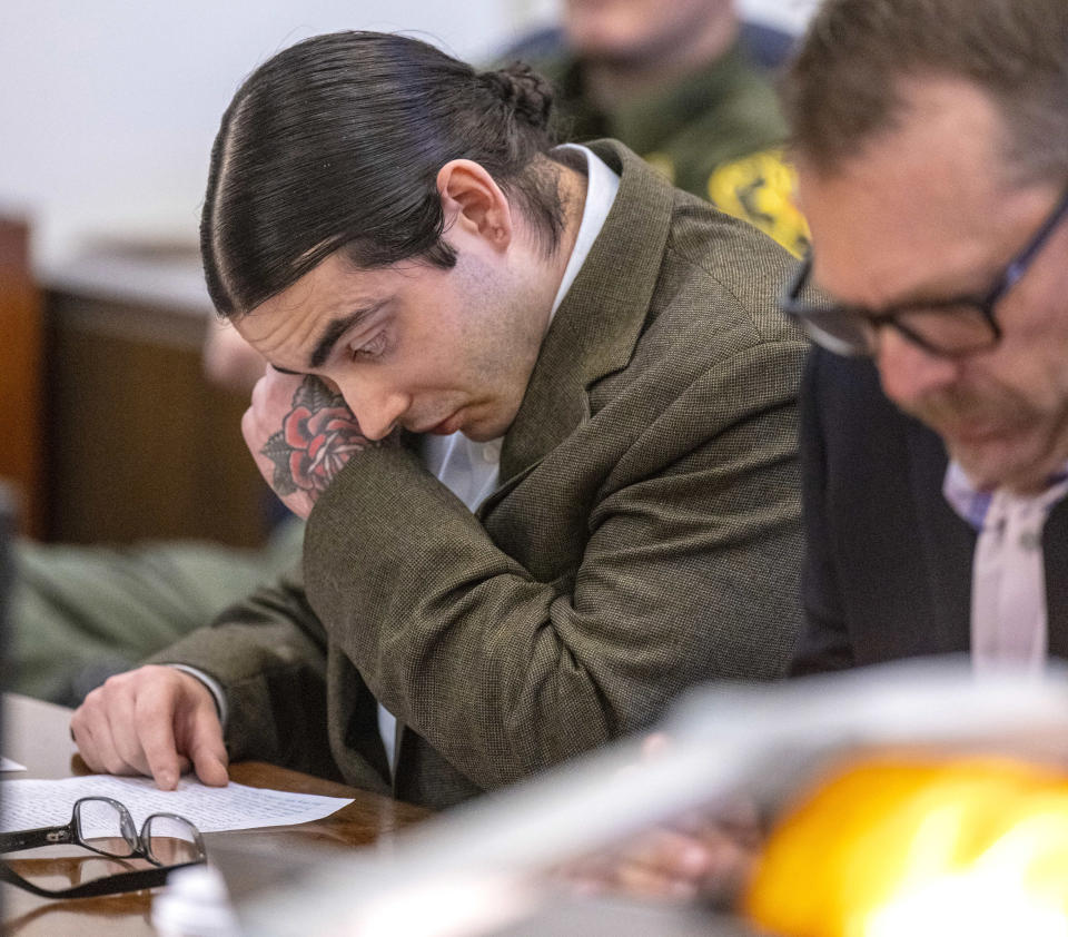 Marcus Eriz, left, wipes his eyes as he reads a statement along side his attorney Deputy Public Defender Randall Bethune during his sentencing, Friday, April 12, 2024, in Santa Ana, Calif. Eriz was sentenced Friday to 40 years to life for the fatal shooting of a 6-year-old boy who was riding in the back of his mother's car on the freeway, prosecutors said. (Mark Rightmire/The Orange County Register via AP)