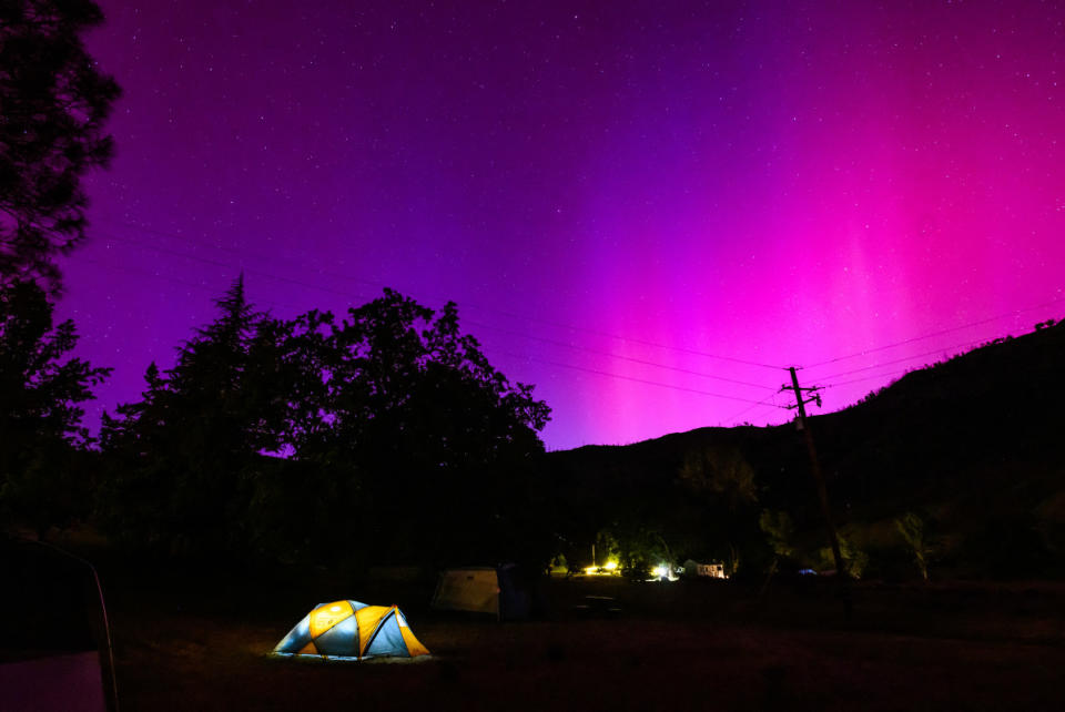<p>Northern lights or aurora borealis illuminate the night sky over a camper's tent north of San Francisco in Middletown, California</p><p>JOSH EDELSON/AFP via Getty Images</p>