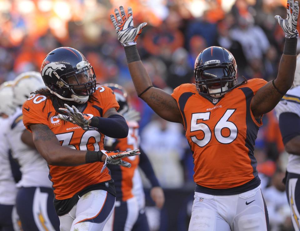 Denver Broncos strong safety David Bruton (30) and outside linebacker Nate Irving (56) react after the San Diego Chargers missed a field goal in the second quarter of an NFL AFC division playoff football game, Sunday, Jan. 12, 2014, in Denver. (AP Photo/Jack Dempsey)