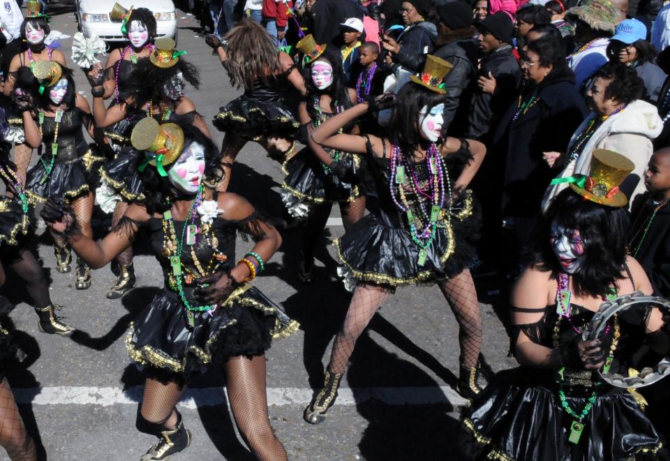 This 2010 photo provided by Jeffry Dupuis shows the Baby Doll Ladies performing in the Zulu krewe parade on Mardi Gras in New Orleans. Baby dolls – groups of women in skimpy or short, ruffled dresses – started with one group of African-American prostitutes wanting to one-up another on Mardi Gras 1912, but spread within decades to respectable black neighborhoods. The tradition had died out is seeing a modern revival. (AP Photo/Courtesy Jeffry Dupuis via New Orleans Society of Dance)