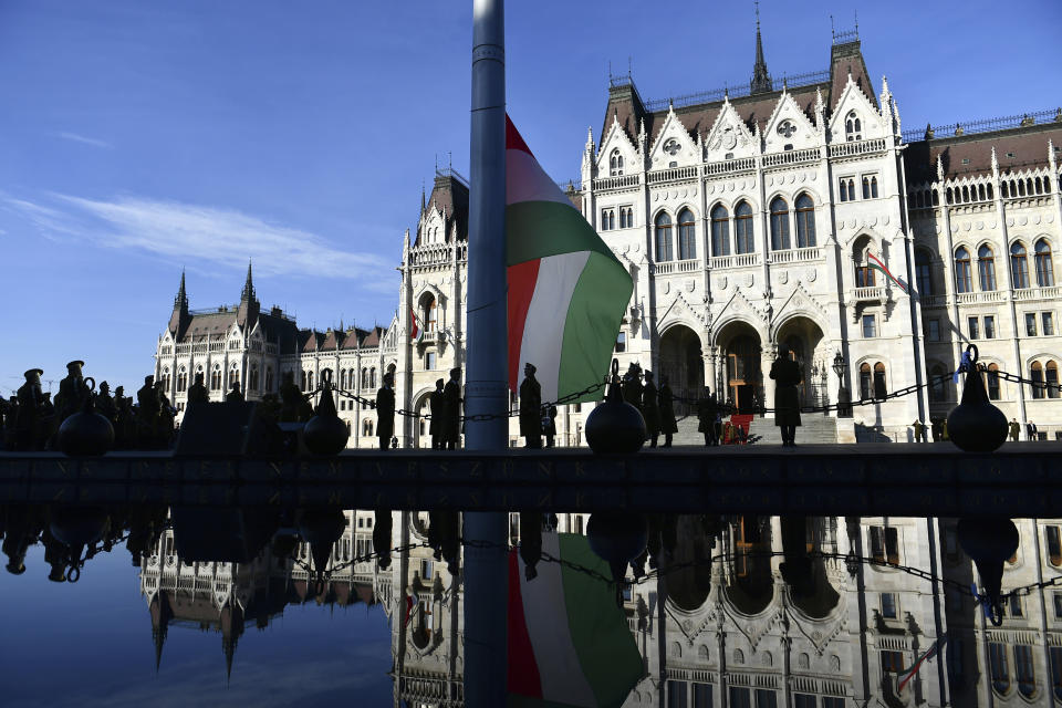 The official flag raising ceremony for the 66th anniversary of Hungarian anti-communist uprising of 1956 in front of the Parliament in Budapest, Hungary, Sunday, Oct. 23, 2022. (AP Photo/Anna Szilagyi)