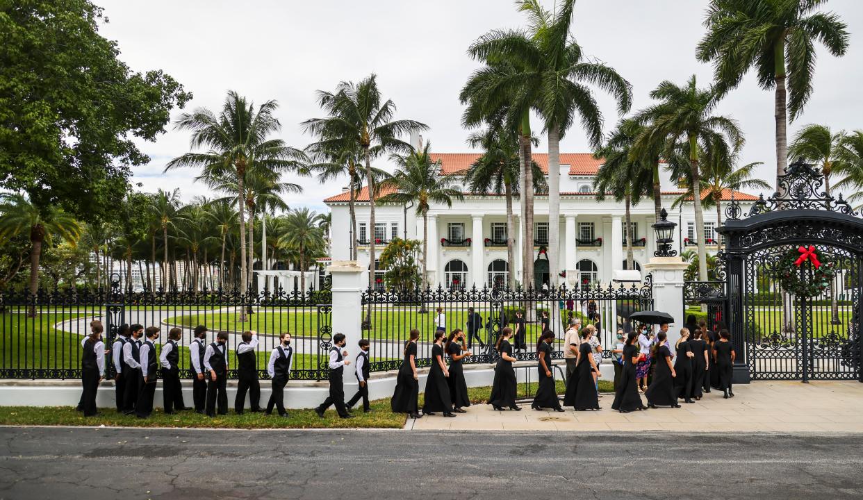 Members of the Bach elementary school choir enter the Flagler Museum to perform holiday songs just before descendants of the Flagler family light a 16-foot-tall Christmas Tree in the Grand Hall, Sunday December 5, 2021.