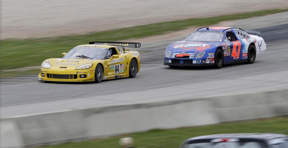 Cars are a blur of action out of turn 5 during the SVRA Vintage Festival Weekend, Saturday, May 15, 2021, at Elkhart Lake's Road America near Plymouth, Wis.