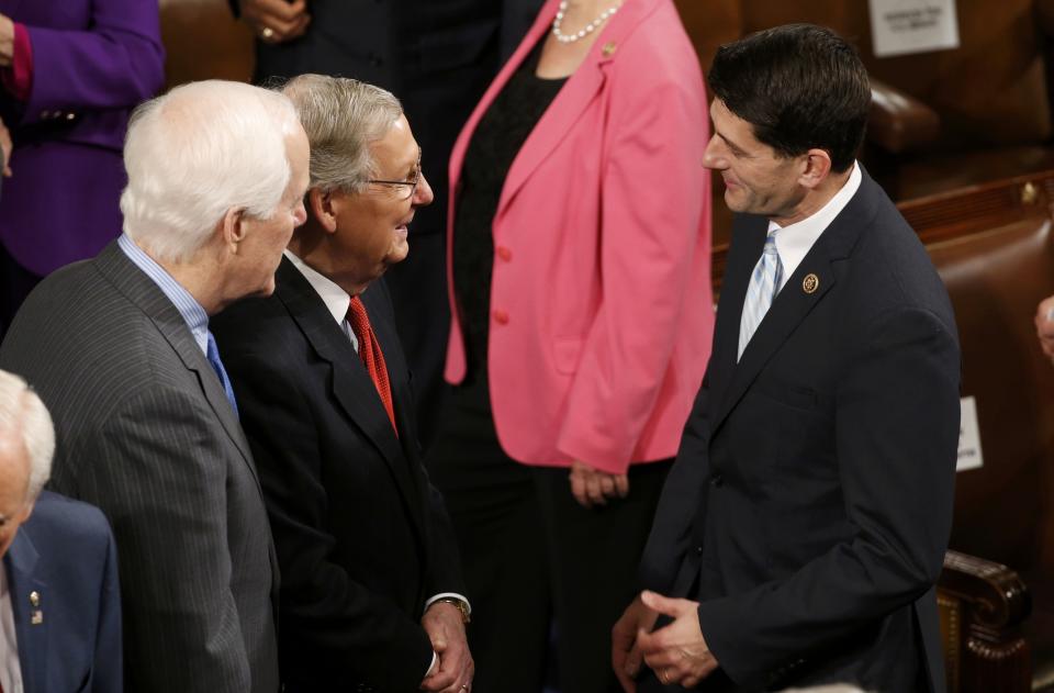 U.S. Senate Minority Whip Cornyn and Senate Majority Leader McConnell talk with Senator Ryan as they wait for President Obama to deliver his State of the Union address to a joint session of the U.S. Congress on Capitol Hill in Washington