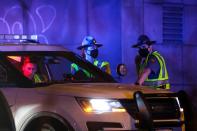 Washington State Troopers investigate the scene where two people in a group of protesters were struck by a car on Interstate 5, in Seattle