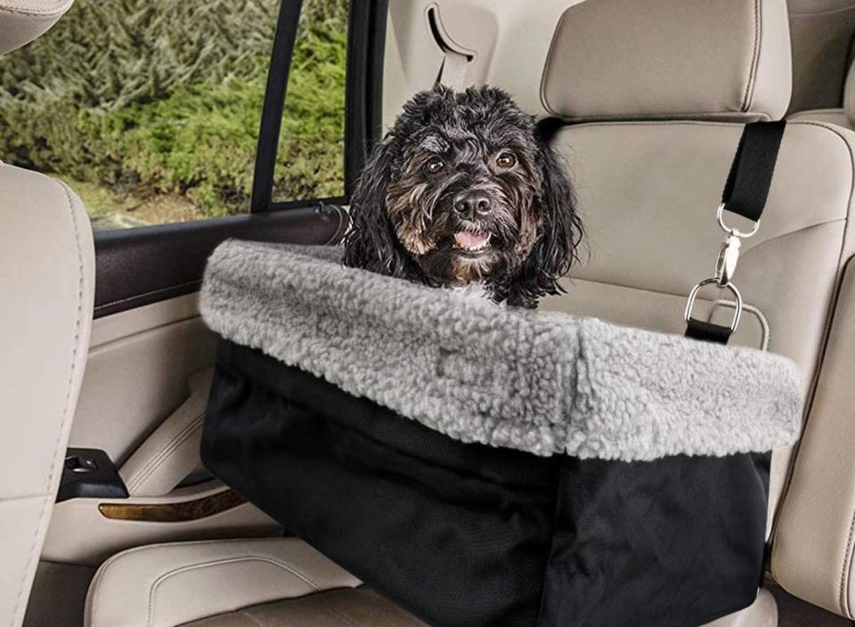 Keep your pup close to you with the help of this car seat that attaches to the headrest of your vehicle.  (Source: Amazon)