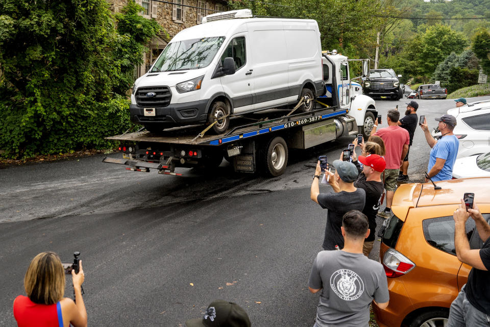 The 2020 Ford Transit van investigators believe fugitive Danelo Calvalcante stole is towed Sunday, Sept. 10, 2023, from Nantmeal Village as the search for the escaped convict moved to northern Chester County. (Tom Gralish/The Philadelphia Inquirer via AP)