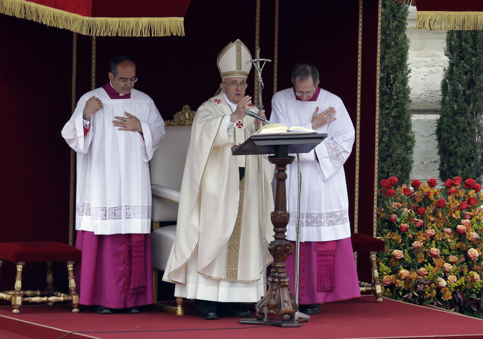 Pope Francis delivers his blessing during a solemn canonization ceremony in St. Peter's Square at the Vatican, Sunday, April 27, 2014. Pope Francis has declared his two predecessors John XXIII and John Paul II saints in an unprecedented canonization ceremony made even more historic by the presence of retired Pope Benedict XVI. (AP Photo/Alessandra Tarantino)