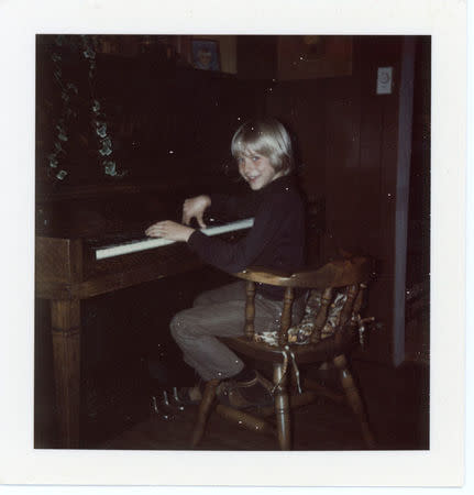 Kurt Cobain is seen playing the piano aged 8 on April 15, 1975 in an image handed out by his family which will form part of an exhibition of his personal items which will be exhibited at Museum of Style Icons in Newbridge, Ireland. Courtesy of the Cobain Family Archive/Handout via REUTERS