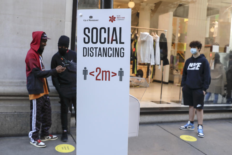 People wait in line for the opening of the Selfridges department store in London, Monday, June 15, 2020. After three months of being closed under coronavirus restrictions, shops selling fashion, toys and other non-essential goods are being allowed to reopen across England for the first time since the country went into lockdown in March.(AP Photo/Matt Dunham)