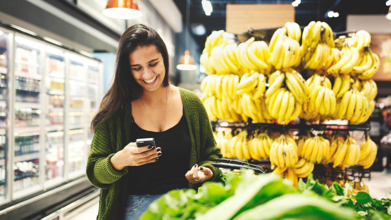 Young woman buying food in a supermarket.