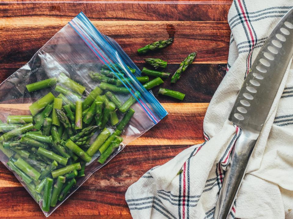 cooked pieces of asparagus in a zip-top bag