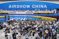 Visitors watch an airshow during the 13th China International Aviation and Aerospace Exhibition, also known as Airshow China 2021, on Tuesday, Sept. 28, 2021, in Zhuhai in southern China's Guangdong province. (AP Photo/Ng Han Guan)