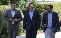 Greek Prime Minister Alexis Tsipras (C), Minister of State Nikos Papas (L) and Government spokesman Gabriel Sakelaridis leave the Presidential Palace for Maximos Mansion after a meeting with party leaders in central Athens, Greece, July 6, 2015. REUTERS/Christian Hartmann
