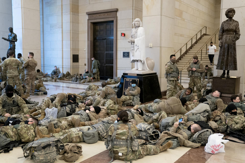 WASHINGTON, DC - JANUARY 13: Members of the National Guard rest in the Visitor Center of the U.S. Capitol on January 13, 2021 in Washington, DC. Security has been increased throughout Washington following the breach of the U.S. Capitol last Wednesday, and leading up to the Presidential inauguration. (Photo by Stefani Reynolds/Getty Images)