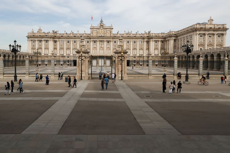 People walk around almost empty square as Royal Palace is closed to the public due to the coronavirus outbreak in central Madrid