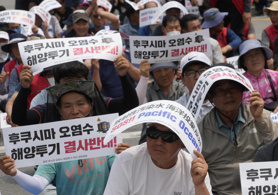 South Korean fishermen attend a rally against the planned release of treated radioactive water from the wrecked Fukushima nuclear power plant, in front of the National Assembly in Seoul, South Korea, Monday, June 12, 2023. The signs read, "Oppose to release treated radioactive water from the Fukushima." (AP Photo/Ahn Young-joon)