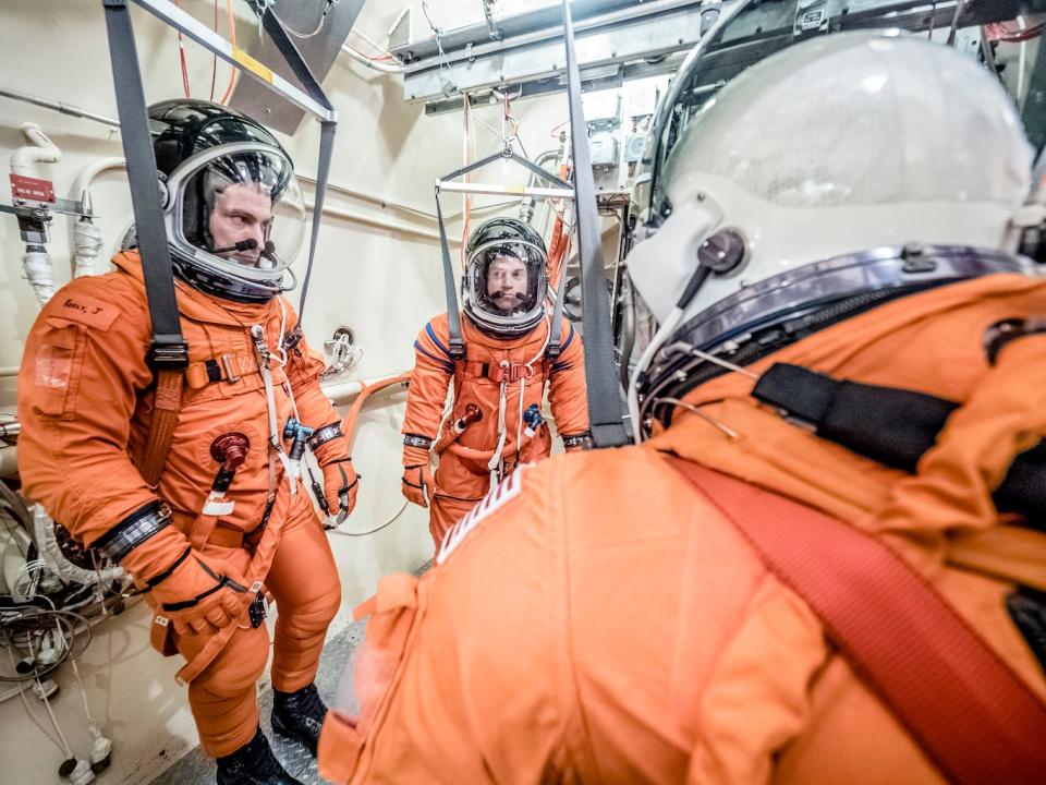 Engineers and technicians at NASA’s Johnson Space Center in Houston test the spacesuit astronauts will wear in the agency’s Orion spacecraft on trips to deep space. This image shows a Vacuum Pressure Integrated Suit Test, in which the suit is connected to life support systems and then air is removed from a thermal vacuum chamber to evaluate the performance of the suits in conditions similar to a spacecraft. <cite>NASA / Radislav Sinyak</cite>