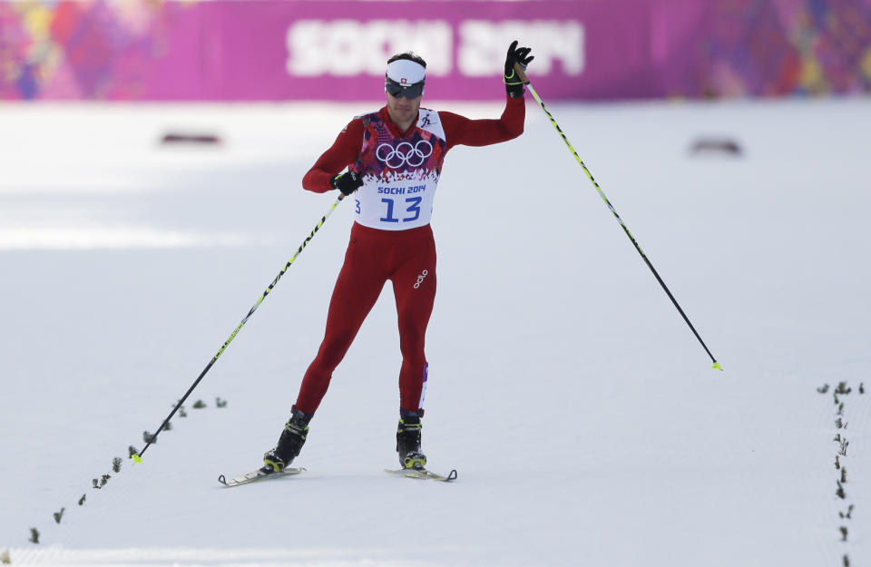 Switzerland's Dario Cologna arrives in the finish after falling twice in his men's quarterfinal heat of the cross-country sprint at the 2014 Winter Olympics, Tuesday, Feb. 11, 2014, in Krasnaya Polyana, Russia. (AP Photo/Matthias Schrader)