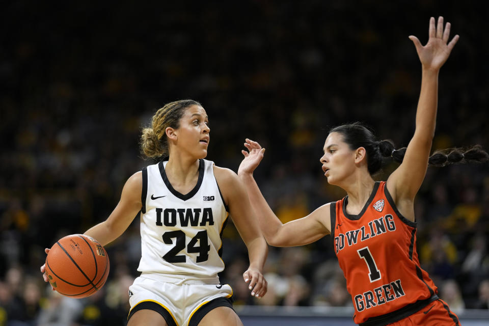 Iowa guard Gabbie Marshall (24) drives past Bowling Green guard Amy Velasco (1) during the first half of an NCAA college basketball game, Saturday, Dec. 2, 2023, in Iowa City, Iowa. (AP Photo/Charlie Neibergall)