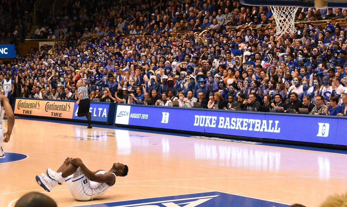 Duke forward Zion Williamson (1) holds his knee after blowing out his shoe early in the game. He did not return and suffered a sprained knee. UNC defeated Duke 88-72 at Cameron Indoor Stadium In Durham, N.C., Wed., Feb.20, 2019.