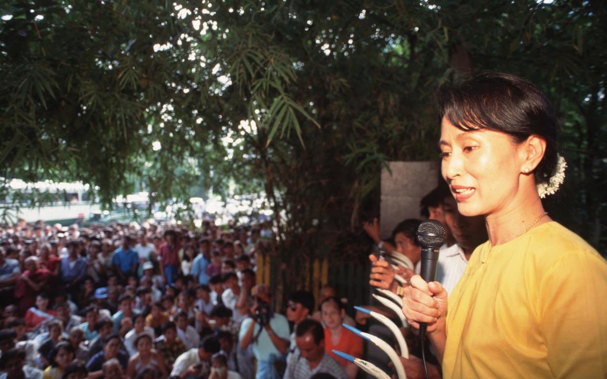 Aung San Suu Kyi used to address crowds over the iron fence of her home - LightRocket