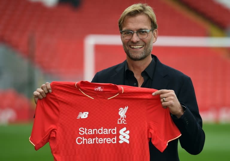 Liverpool manager Jurgen Klopp poses with a team jersey at Anfield on October 9, 2015