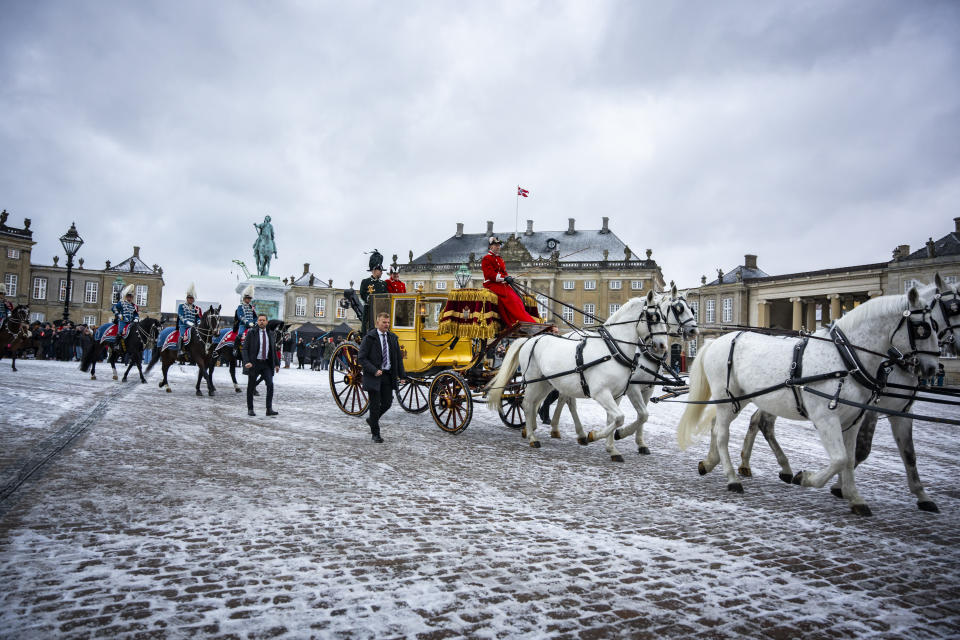 Denmark's Queen Margrethe is escorted by the Hussar Regiment as she rides in a horse-drawn coach from Christian IX's Palace, Amalienborg to Christiansborg Palace in Copenhagen, Denmark, Thursday Jan. 4, 2024. Europe's longest reigning monarch Queen Margrethe rode through Denmark’s capital Thursday in a gilded, horse-drawn coach as she concluded her last New Year celebrations before her abdication later this month. (Emil Nicolai Helms/Ritzau Scanpix via AP)