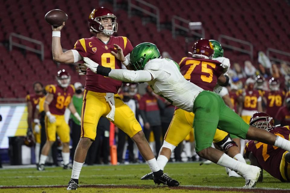 USC quarterback Kedon Slovis is tackled by Oregon defensive end Kayvon Thibodeaux.