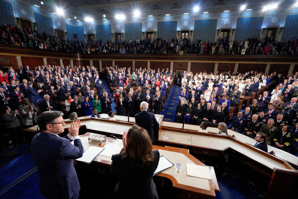 Speaker of the House Mike Johnson and Vice President Kamala Harris applaud as President Biden delivers the State of the Union address 