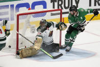 Minnesota Wild goaltender Marc-Andre Fleury (29) deflects a shot as Dallas Stars center Tyler Seguin, right, pressures the net in the third period of Game 2 of an NHL hockey Stanley Cup first-round playoff series, Wednesday, April 19, 2023, in Dallas. (AP Photo/Tony Gutierrez)
