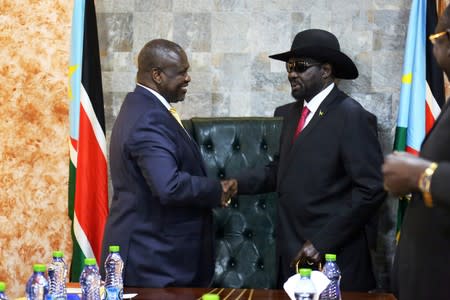 South Sudan's President Salva Kiir Mayardit shakes hands with ex-vice president and former rebel leader Riek Machar during their meeting in Juba