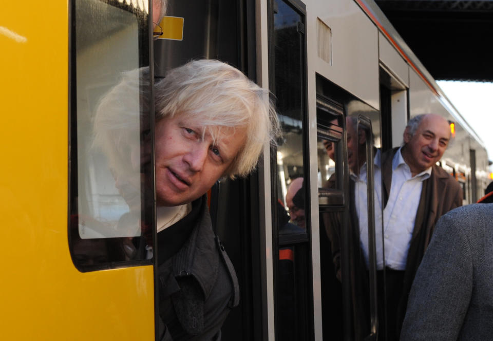 London Mayor Boris Johnson boards one of the first trains of the new London Overground extension connecting Clapham Junction with Canada Water. ASSOCIATION Photo. Picture date: Monday December 10 2012. The new service will be London's first new orbital Journey times from south and east London. See PA story RAIL Link. Photo credit should read: Stefan Rousseau/PA