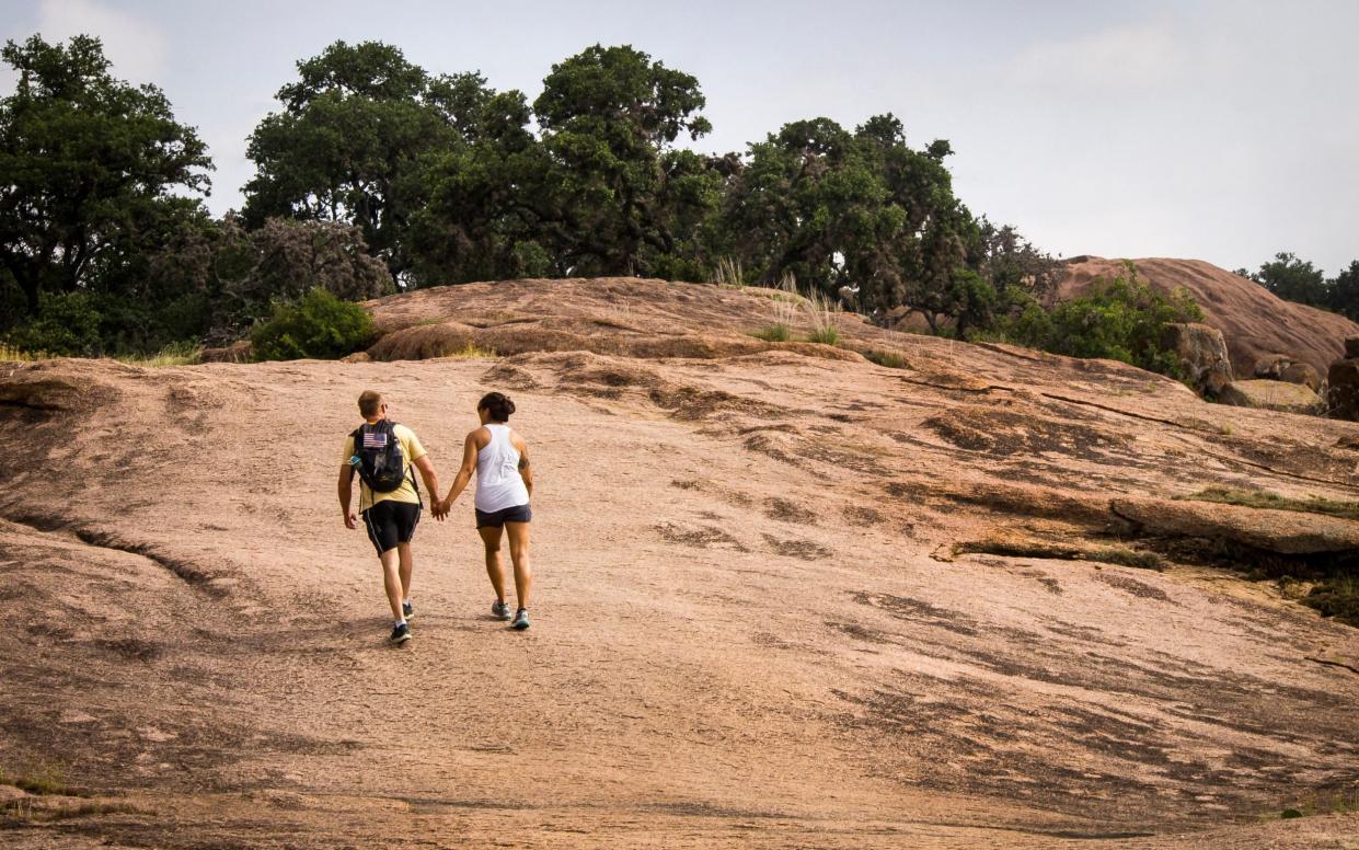 Enchanted Rock, a 425ft golden-pink granite rock formation outside of Fredericksburg