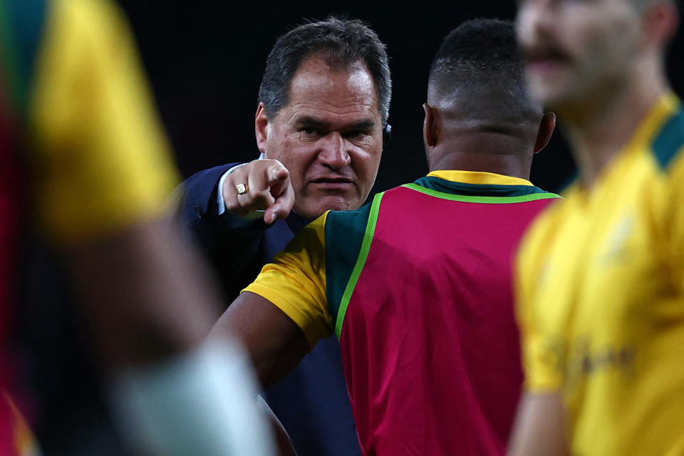 Seen here, Wallabies coach Dave Rennie gives instructions to his players before a rugby Test.