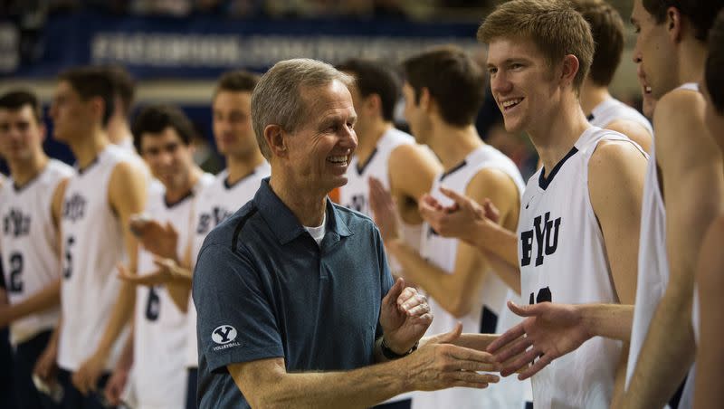 Former BYU volleyball coach Carl McGown interacts with a player during match against Pepperdine.