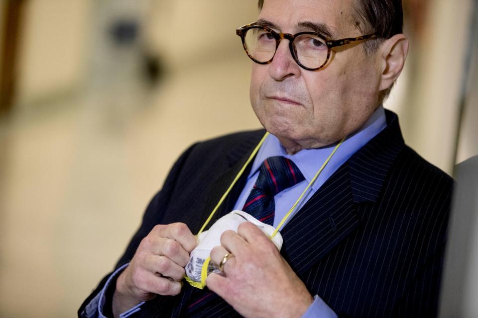 Rep. Jerrold Nadler holds his face mask as he appears before members of the media following a House Judiciary Committee closed door meeting.