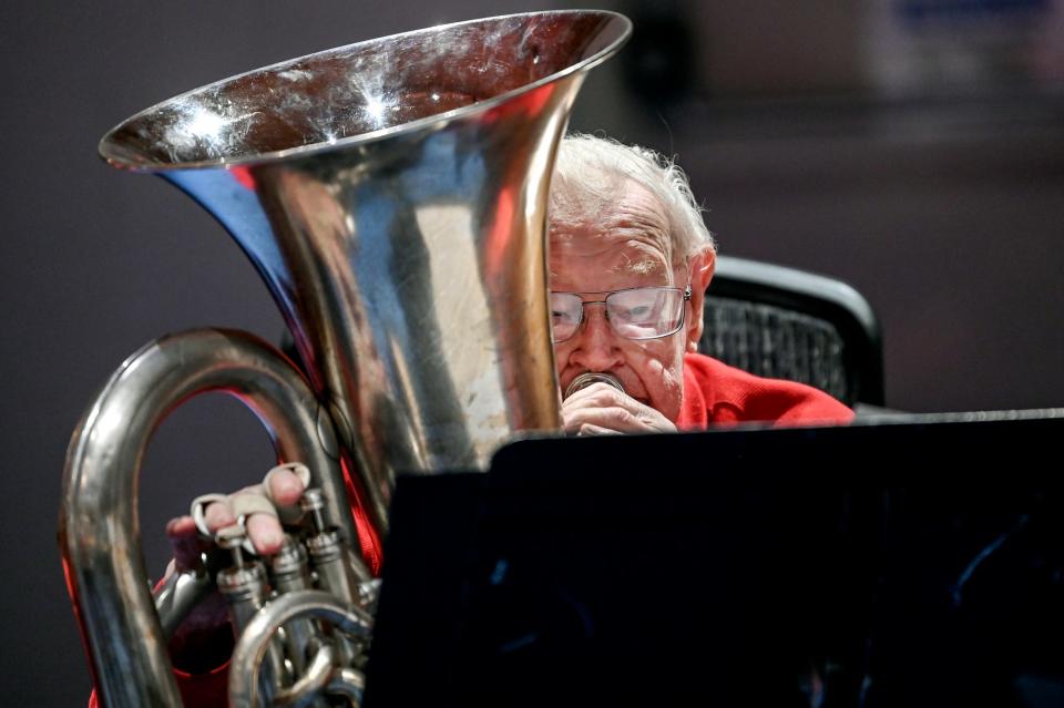 Henry Nelson, 100, plays his tuba in the Asbury Brass Quintet during a performance on Wednesday, Dec. 7, 2022, at Ascension Lutheran Church in East Lansing.  Nelson started playing tuba decades ago, stopped for a while and picked it back up for the past 20 years. He has been playing the flute and piccolo for more than 80 years.