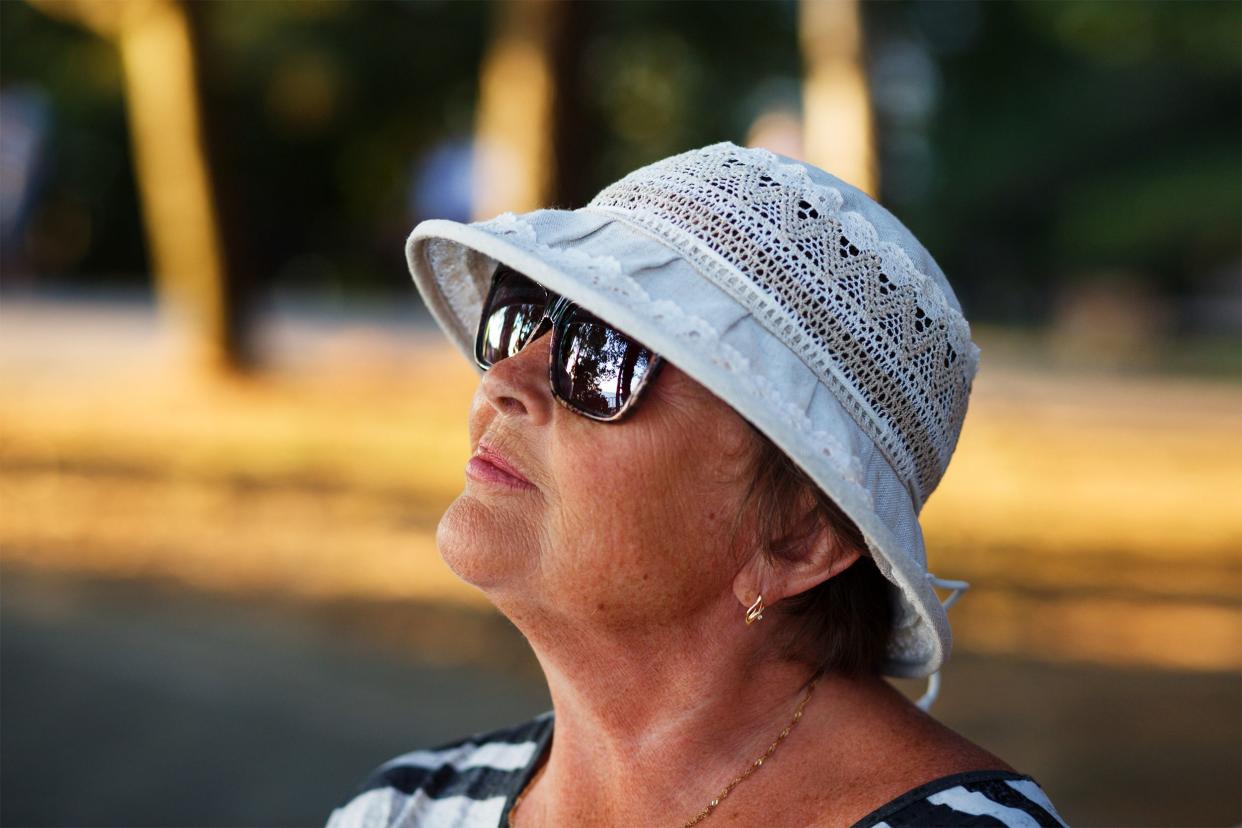 Senior woman wearing sunglasses and a hat