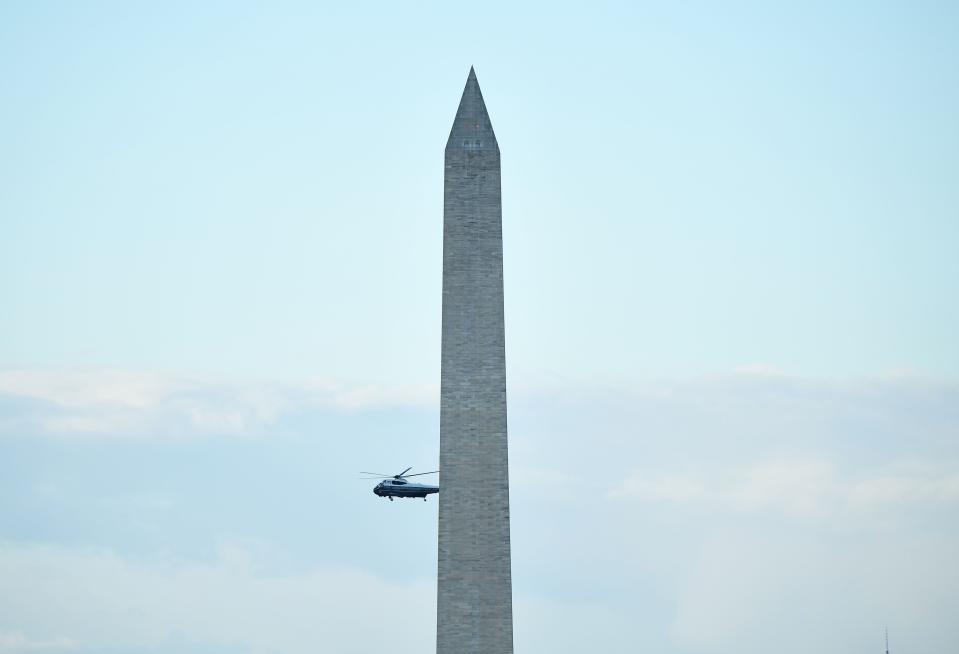 Marine One with President Donald Trump and First Lady Melania Trump flies past the Washington Monument as it departs the White House in Washington, D.C., en route to Joint Base Andrews, Maryland, on January 20, 2021.