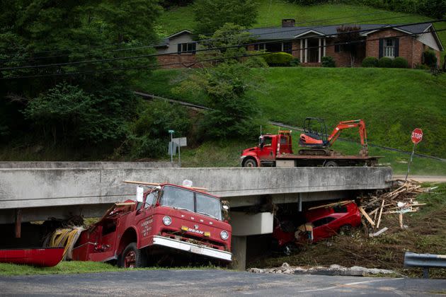 A car and a vintage Hindman Fire Department fire truck remain under a bridge after being washed up by floodwaters in Hindman, Kentucky, on July, 30. (Photo: Arden S. Barnes/For The Washington Post/Getty Images)