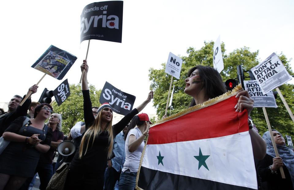 Activists block Whitehall near the junction with Downing Street during an event organised by Stop the War Coalition to protest against potential UK involvement in the Syrian conflict in London.