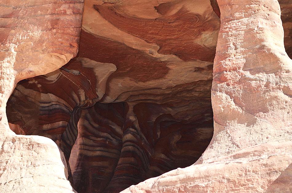 The Street of Facades in Petra is lined with rock-cut tombs in sandstone. Bodies were interred in chambers carved on the rocks.